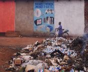 /u/edme took this photo of an annoying sign in Zambia not realizing there was a guy dead or at the very least passed out in a pile of trash (lower right corner) from zambia xx pic